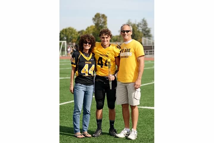Danny Holton, football Danny Holton with his mom and dad, Carolyn and John, at a high school football game.