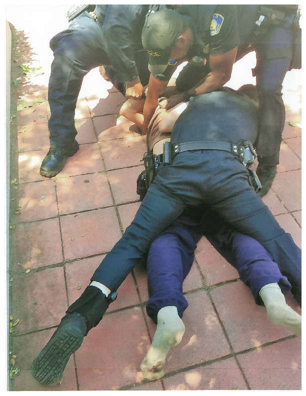 Whittier police officers struggle with Jonathan Salcido on May 4 after his mother called for their assistance in transporting him to a psychiatric hospital. Salcido, 27, died a short time later, according to a legal claim filed by the family.
