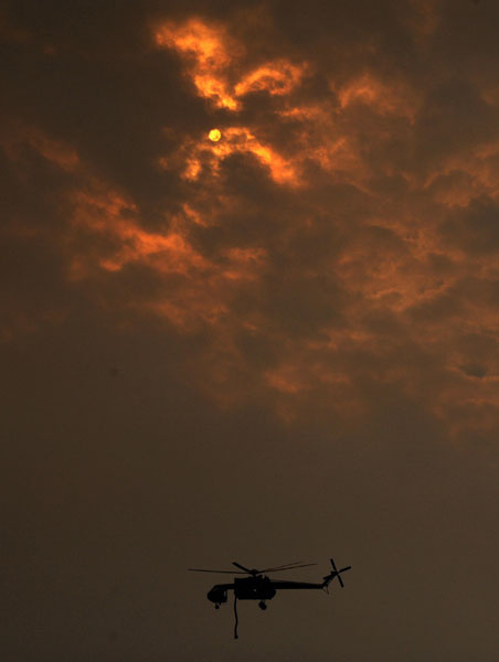 A helicopter fights to save a house in La Crescenta in 2009
