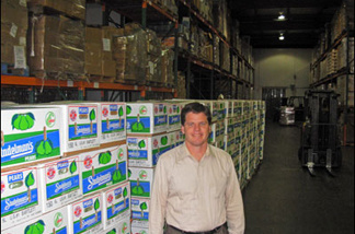 Mercer 8066 Michael Flood, executive director of the L.A. County Regional Food Bank, next to pears that will feed the hungry. When the U.S. government cut back on the food it gave out, the Food Bank made up the gap with fresh produce.