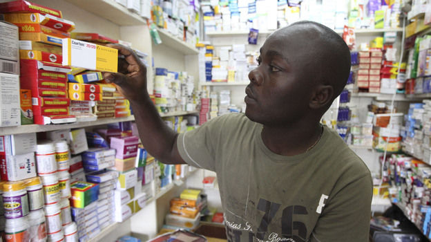 Ayo Bello grabs a box of malaria medication at a pharmacy in Lagos, Nigeria. A pilot project by the Global Fund has helped private pharmacies and clinics sell top quality malaria drugs at wholesale prices in Nigeria and seven other African countries.