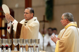 File photo: Cardinal Roger Mahony (L) offers the Eucharist while Archbishop Jose H. Gomez looks on during a welcoming Mass at the Cathedral of Our Lady of the Angels May 26, 2010 in Los Angeles, California.