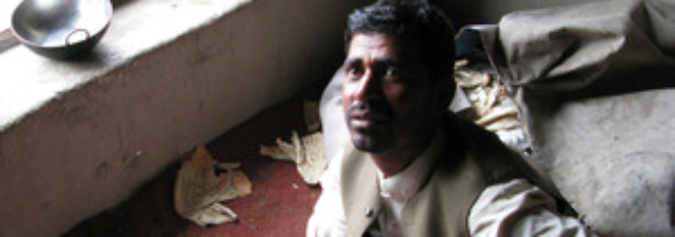 Raifudin Kushkaki shows where he says his 16-year-old son bled to death during a May 14 U.S.-Afghan military raid on his home near Jalalabad in eastern Afghanistan. Kushkaki says the raid killed nine innocent civilians. U.S. officials say the raid targeted and killed a Taliban operative