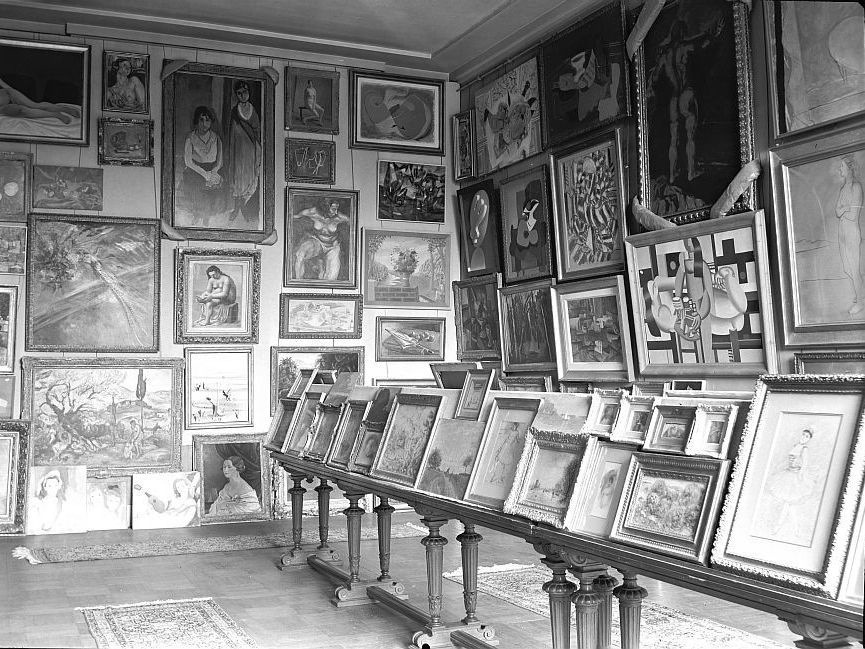 A photo taken by the Nazis during World War II shows a room filled with stolen art at the Jeu de Paume museum in Paris. Using improved technology and the Internet, the French government is making a renewed push to track down the rightful owners of art looted by the Nazis.