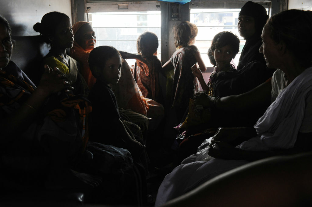 Indian women and children wait inside a darkened train carriage at a railway station in New Delhi on July 31, 2012. A massive power failure hit India for the second day running as three regional power grids collapsed, blacking out more than half the country in a crisis affecting over 600 million people.
