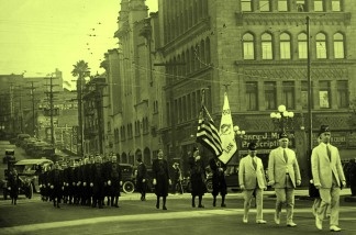 Mercer 18408 Undated photo of a Shriners parade walking past 5th and Olive Streets in Downtown LA. On the right corner is the Philharmonic Auditorium Building, which shared space with Temple Baptist Church.