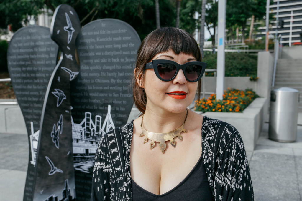 Artist Miyo Stevens-Gandara stands next to her angel,