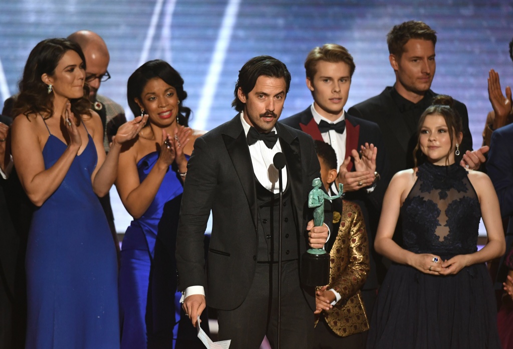 US-ENTERTAINMENT-SAG-FILM-AWARDS-SHOW Milo Ventimiglia (C) and the cast from 'This Is Us' accept the award for Outstanding Performance by an Ensemble in a Drama Series during the 24th Annual Screen Actors Guild Awards show at The Shrine Auditorium on January 21, 2018 in Los Angeles, California.