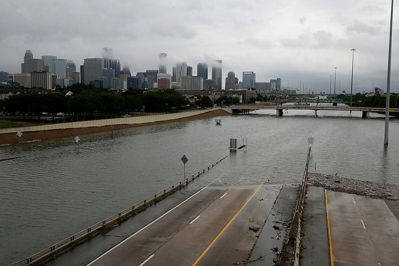gettyimages-839994934_slide-e16bd6c0fca7d4d06cb687443c29d043a7ca97e1-s800-c85.jpg The downtown Houston skyline and flooded Highway 288 are shown on Sunday.