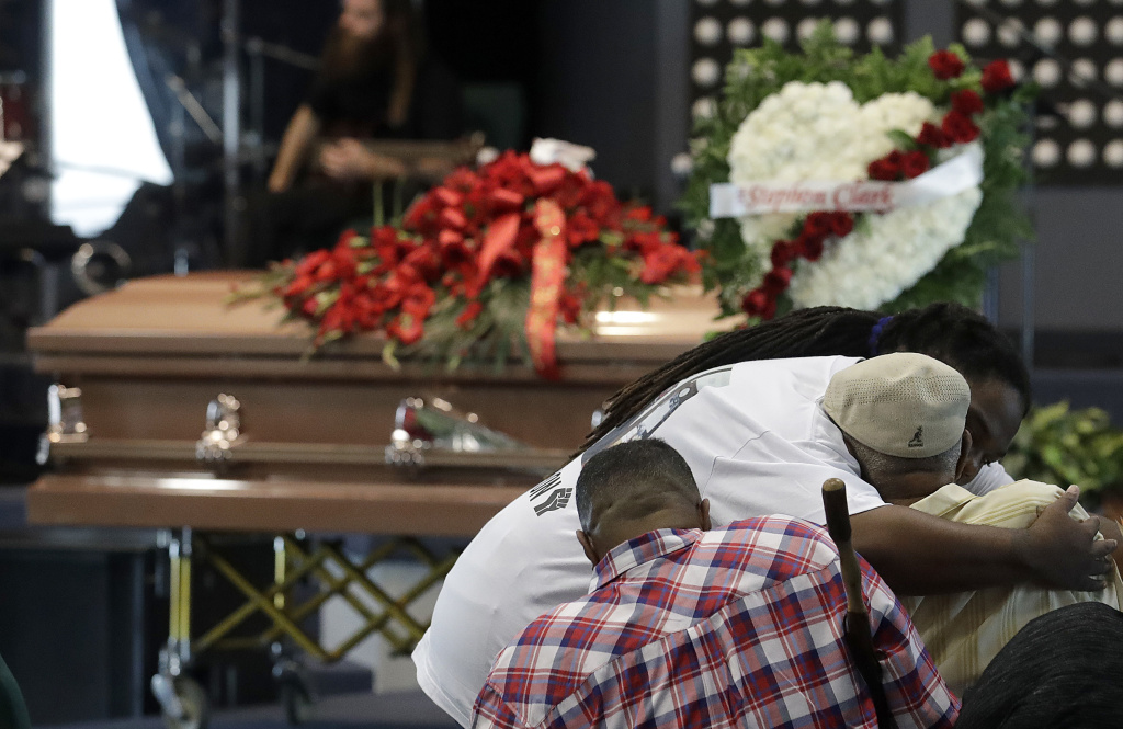 Sacramento Police Shooting A man hugs another man before funeral services for Stephon Clark at Bayside Of South Sacramento Church, known as BOSS Church, in Sacramento, Calif., Thursday, March 29, 2018. Clark, who was unarmed, was shot and killed by Sacramento Police Officers on Sunday, March 18. (AP Photo/Jeff Chiu, Pool)