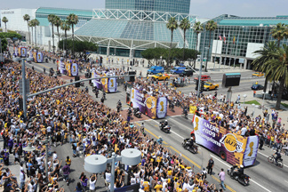 Fans cheers as The Los Angeles Lakers ride down the street on double decker buses during their 2009 NBA championship victory parade, in downtown Los Angeles, California on June 17, 2009. The Lakers say they are going to pay for the parade if they win this year.