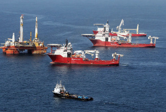Oil sheen is seen with vessels assisting near the source of the BP Deepwater Horizon oil spill July 23, 2010 in the Gulf of Mexico off the coast of Louisiana.