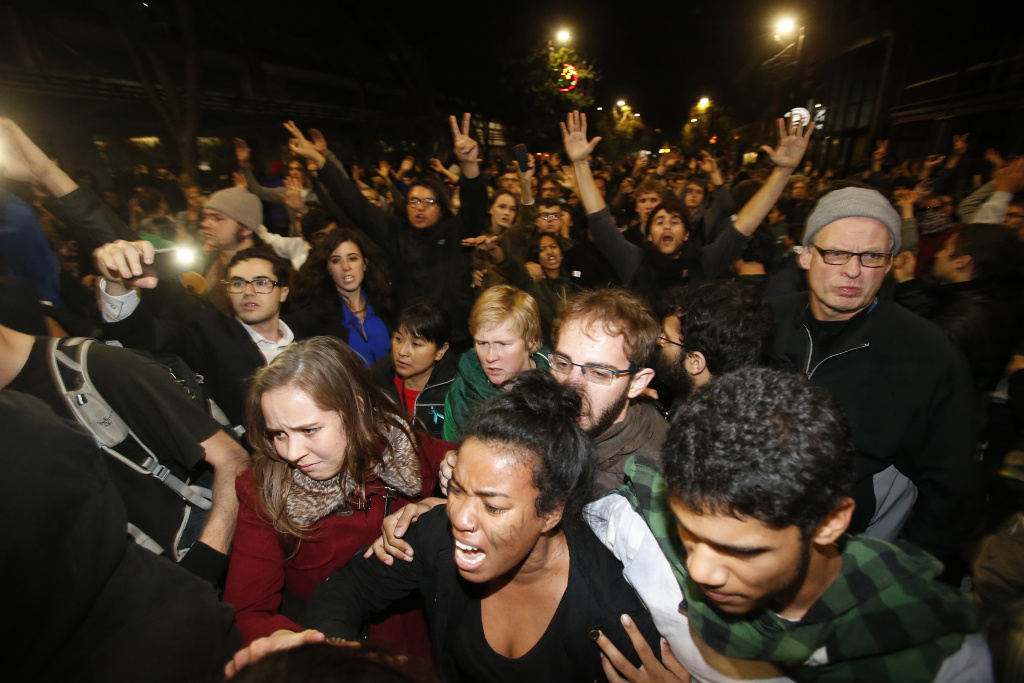 Demonstrations Over Recent Grand Jury Decisions In Police-Involved Deaths Continue BERKELEY, CA - DECEMBER 7: Demonstrators react as they were being push by by the police on Telegraph Ave during a demonstration over recent grand jury decisions in police-involved deaths on December 7, 2014 in Berkeley, California. A Staten Island, New York grand jury declined on Wednesday to indict New York City Police Officer Daniel Pantaleo in the chokehold death of Eric Garner.