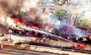 A fire department crew sprays water on a burning mini-mall in South Los Angeles, April 30, 1992