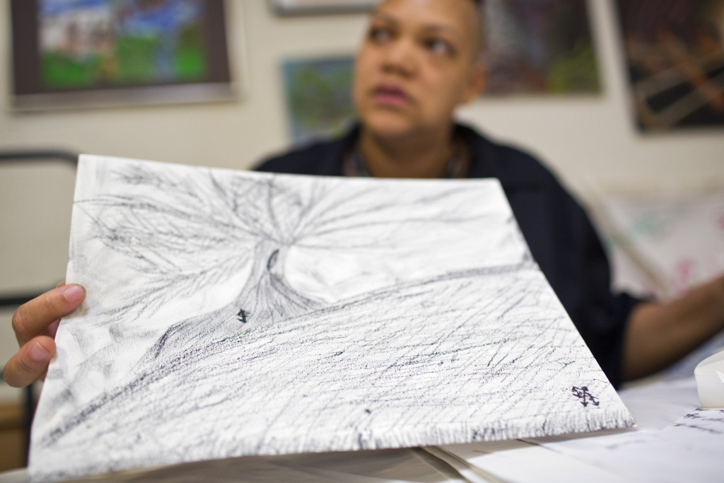 Homeless Housing Push - 7 Mykael Williams-Wolf holds a piece he made with loose charcoal. LAMP's arts program first started in 1999 and is aimed towards creating a creative space for people who are homeless, living in extreme poverty or have a mental illness.