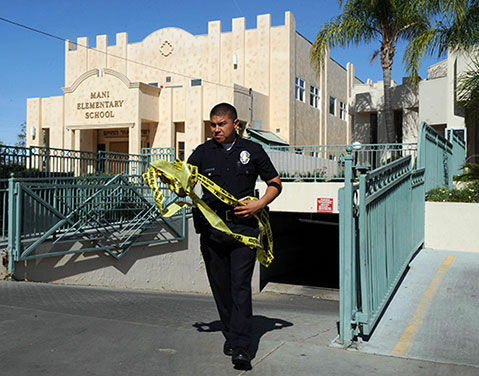 A policeman takes down crime tape.