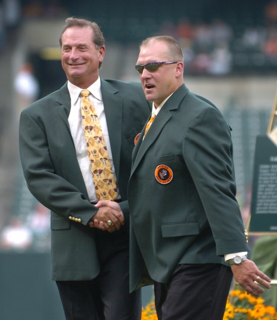 Former Baltimore Orioles' Doug DeCinces, left, and Chris Hoiles shake hands after being inducted into the Orioles Hall of Fame during a ceremony before the Orioles' baseball game against the Tampa Bay Devil Rays on Saturday, Aug. 26, 2006, in Baltimore.