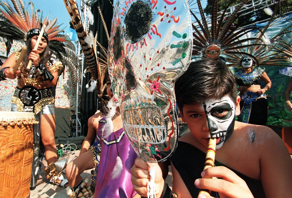 A boy plays the flute during a celebration of A boy plays the flute during a celebration of