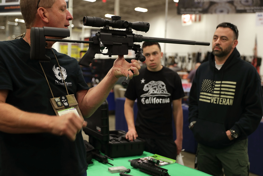 Major Gun Show Held In Virginia A gun seller demonstrates a firearm to potential buyers during the Nation's Gun Show on November 18, 2016 at Dulles Expo Center in Chantilly, Virginia.