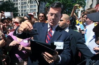 Comedian Stephen Colbert scans a credit card for a donation after attending a Federal Election Commission (FEC) hearing to ask for a media exemption to create a political action committee (PAC) on June 30, 2011 in Washington, DC. Colbert was given the go ahead from the FEC to launch a super political action committee to raise unlimited amounts of campaign cash for the upcoming 2012 political season.
