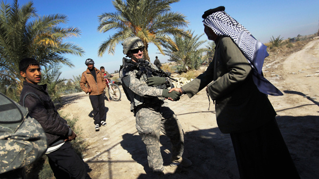 U.S. Army Lt. Adam Wilson from Ontario, Calif., shakes hands with Sheik Mahmood Al-Ghizzi, possibly for the last time, on Dec. 5 in Nasiriyah, Iraq. The two men met for a final lunch as the U.S. military prepares to leave Iraq after a nearly nine-year presence.