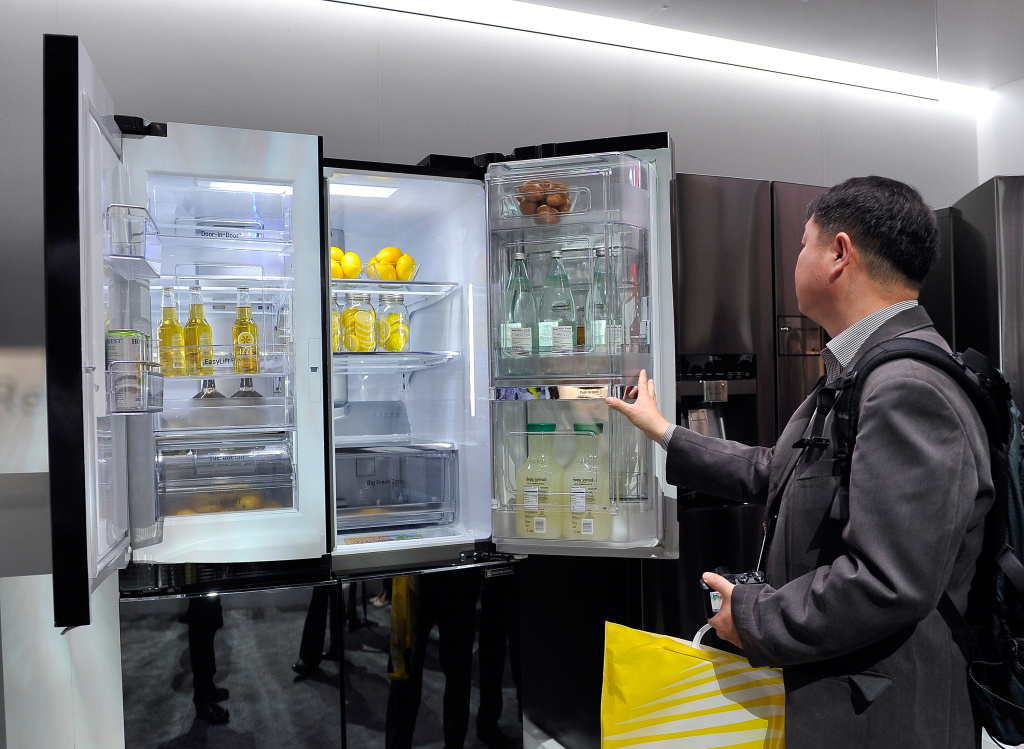 Newest Innovations In Consumer Technology On Display At 2015 International CES LAS VEGAS, NV - JANUARY 06: An attendee looks over the LG Double Door-in-Door refrigerator at the 2015 International CES at the Las Vegas Convention Center on January 6, 2015 in Las Vegas, Nevada. CES, the world's largest annual consumer technology trade show, runs through January 9 and is expected to feature 3,600 exhibitors showing off their latest products and services to about 150,000 attendees.