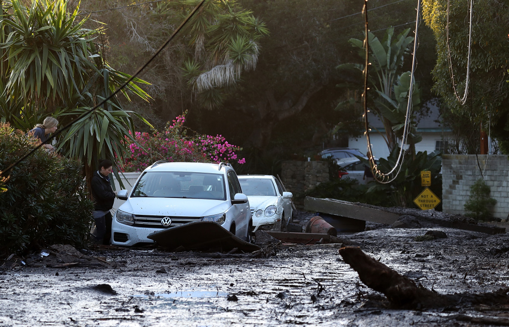 Mudslides Kill At Least 17 People In Santa Barbara County Where Wildfire Scorched Hillside A resident looks into her car that sits in mud and debris from a mudslide on January 11, 2018 in Montecito, California.