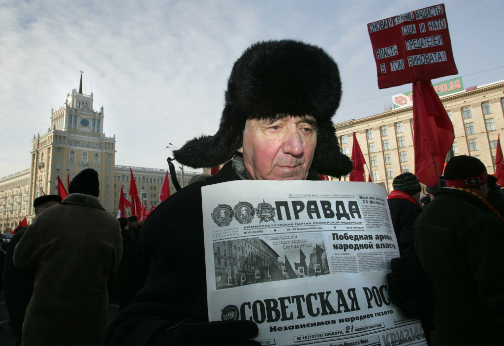 A Russian Communist Party supporter hold A Russian Communist Party supporter holds pro-communist newspapers