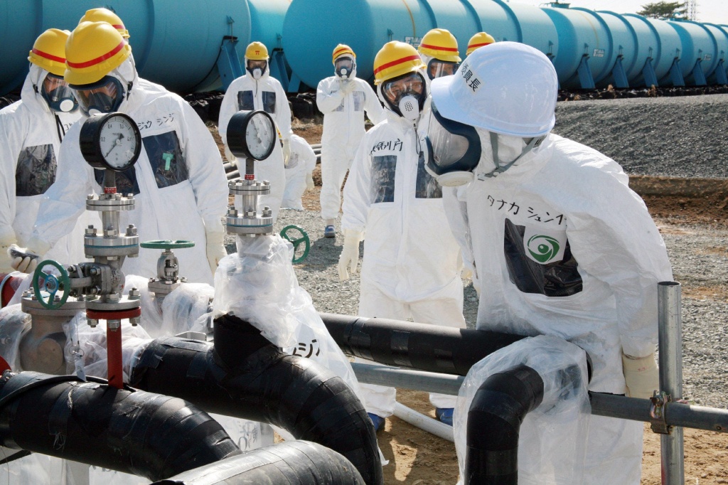 Nuclear Regulation Authority (NRA) Secretary General Shunichi Tanaka (R, w/white helmet) inspects the radioactive water-leaked plumbing with Tokyo Electric Power Co. (TEPCO) officials at the Fukushima Dai-Ichi nuclear power plant in Okuma in Fukushima prefecture, on April 13, 2013. (Photo by JIJI PRESS/AFP/Getty Images) Nuclear Regulation Authority (NRA) Secretary General Shunichi Tanaka (R, w/white helmet) inspects the radioactive water-leaked plumbing with Tokyo Electric Power Co. (TEPCO) officials at the Fukushima Dai-Ichi nuclear power plant in Okuma in Fukushima prefecture, on April 13, 2013. (Photo by JIJI PRESS/AFP/Getty Images)