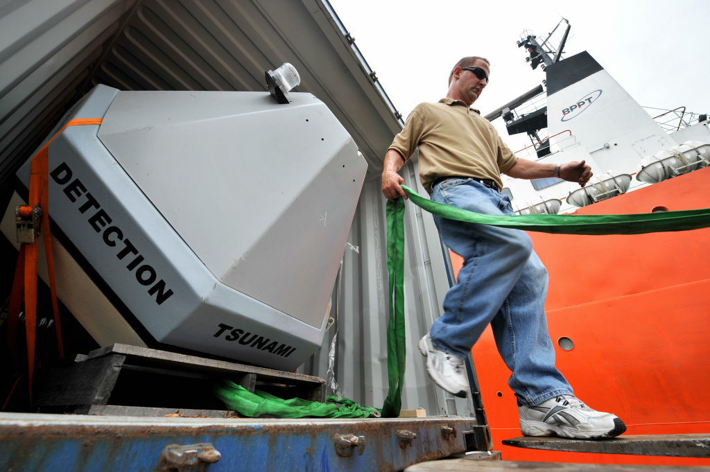A technician unloads a tsunami detection buoy A technician from the US National Oceanographic and Atmospheric Administration (NOAA) prepares to unload a Tsunami Buoy, a device to detect early tsunami warnings.