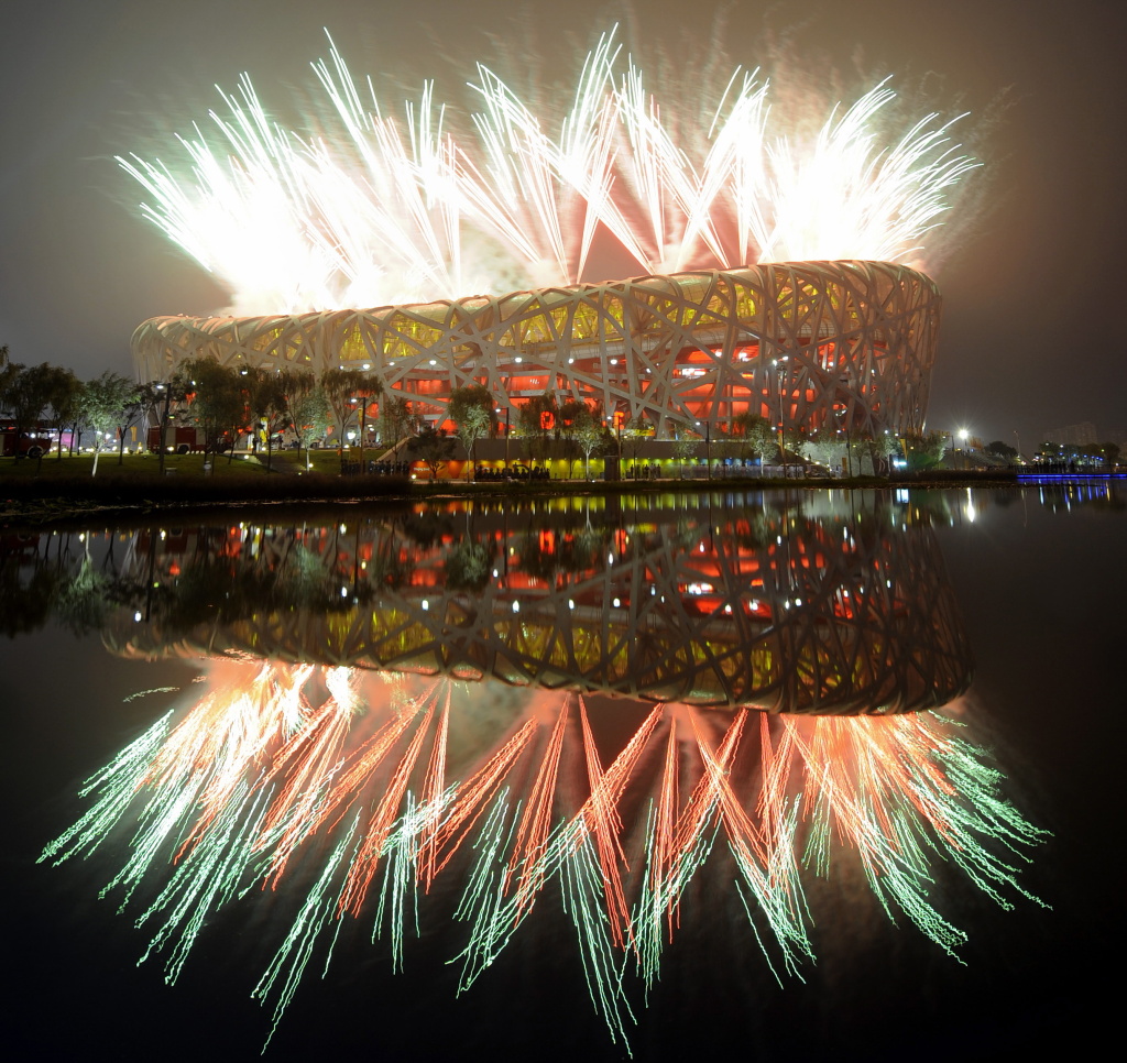 Fireworks explode next to the National S Fireworks explode next to the National Stadium, also known as the