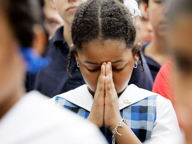 Alexandria McPherson, 8, prays during a National Day of Prayer gathering at City Hall in San Antonio in 2007.