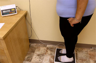 A student weighs in at Wellspring Academy, a special school in Reedley, Calif., that incorporates weight loss with academic studies.