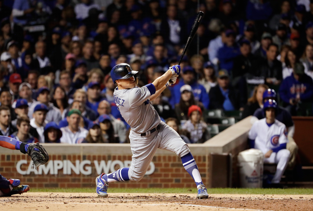 League Championship Series - Los Angeles Dodgers v Chicago Cubs - Game Five Enrique Hernandez #14 of the Los Angeles Dodgers hits a grand slam in the third inning against the Chicago Cubs during game five of the National League Championship Series at Wrigley Field on October 19, 2017 in Chicago, Illinois.