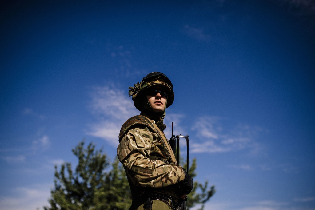 A Ukrainian soldier stands guard at a checkpoint on a road near the city of Dnepropetrovsk on August 25, 2014.