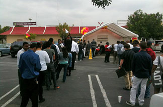 Dozens of job seekers line up in parking lot of McDonald's on La Cienega Blvd. near Baldwin Hills.
