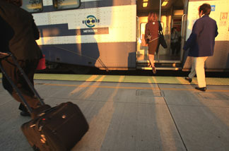 Passengers board a Metrolink train for the Los Angeles-bound morning commute.