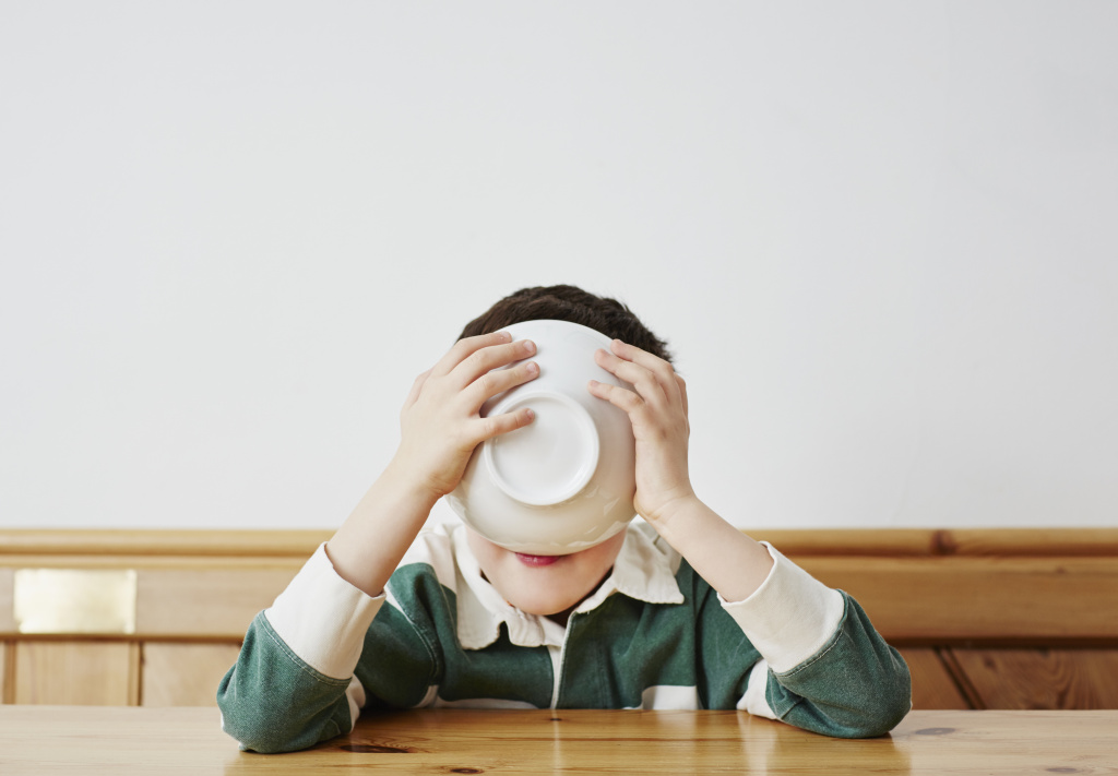 Boy drinking milk from bowl
