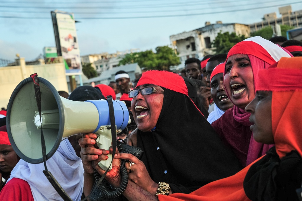 SOMALIA-BOMBING-CONFLICT-PROTEST People chant slogans as they protest after a truck bomb exploded outside of the Safari Hotel in Mogadishu on October 15, 2017.