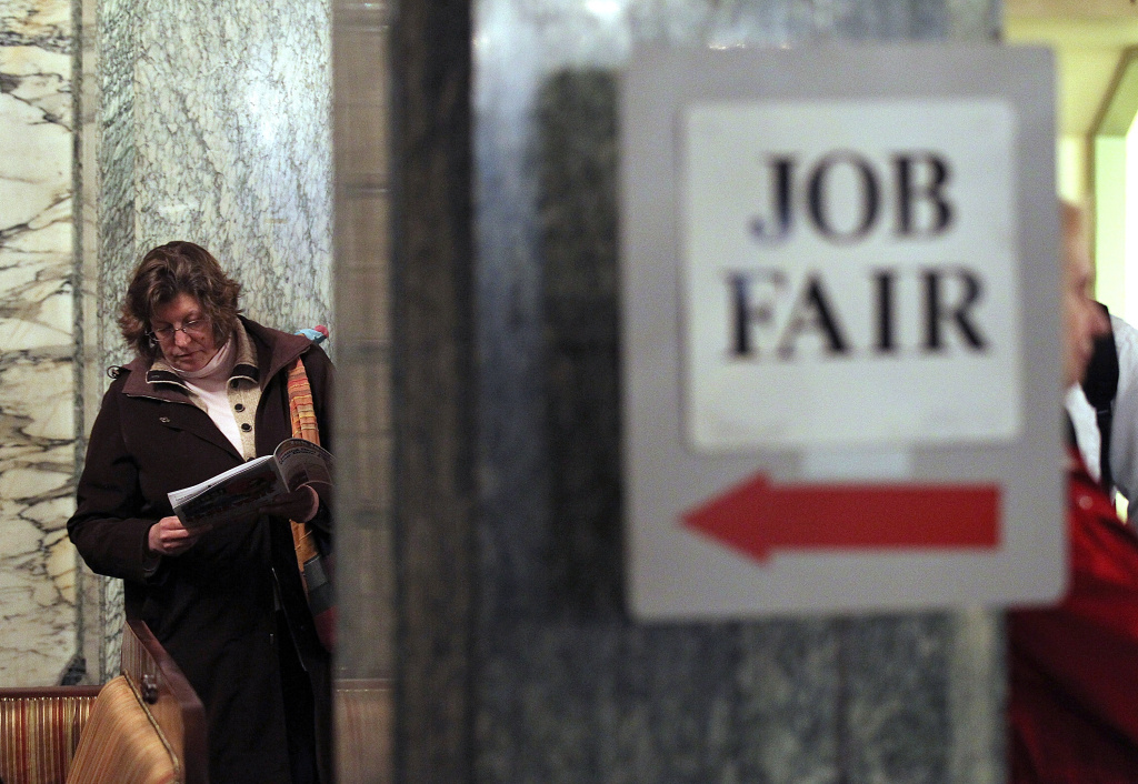 SAN FRANCISCO, CA - MARCH 27: A job seeker looks over event materials as she waits to enter the San Francisco Hirevent job fair at the Hotel Whitcomb on March 27, 2012 in San Francisco, California. As the national unemployment rate stands at 8.3 percent, job seekers turned out to meet with recruiters at the San Francisco Hirevent job fair where hundreds of jobs were available. (Photo by Justin Sullivan/Getty Images)