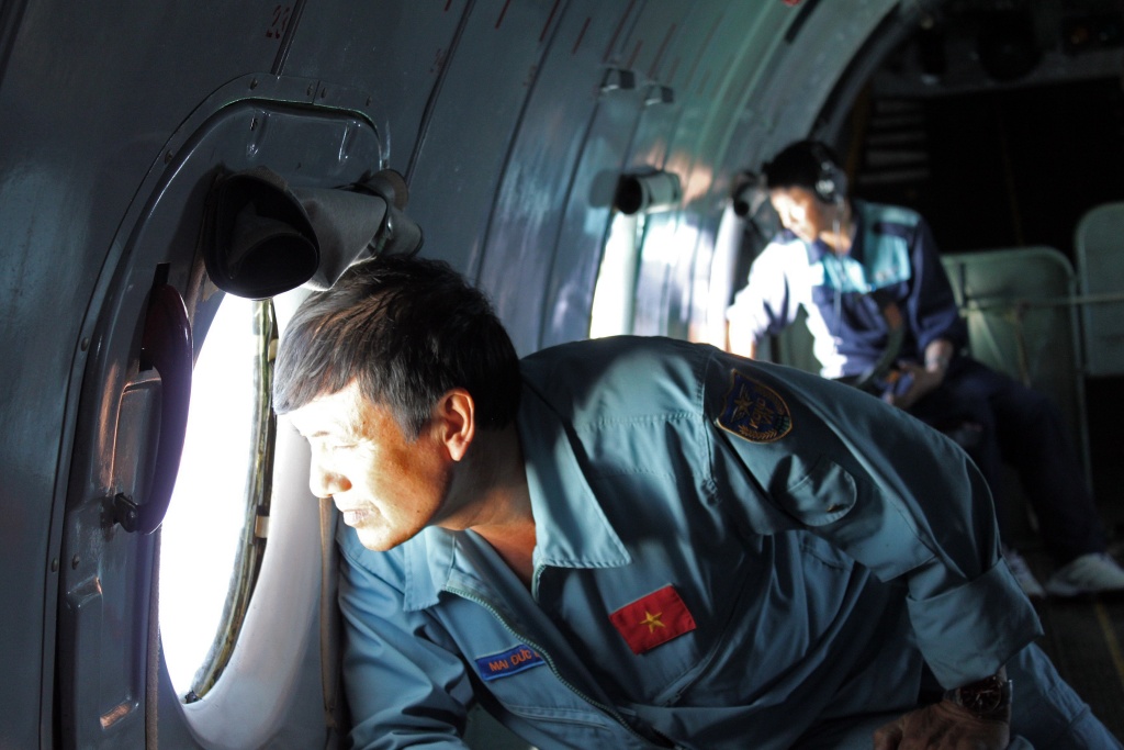Search Continues For Missing Malaysian Arliner Carrying 239 Passengers This picture taken on March 8, 2014 shows military personnel scanning the sea aboard a Vietnamese Air Force aircraft taking part in a search mission for a missing Malaysia Airlines aircraft, somewhere between Malaysia's east coast and southern Vietnam. Malaysia Airlines said on March 9 that it was 'fearing the worst' for the passenger jet that vanished carrying 239 people, as search teams hunt for the plane.