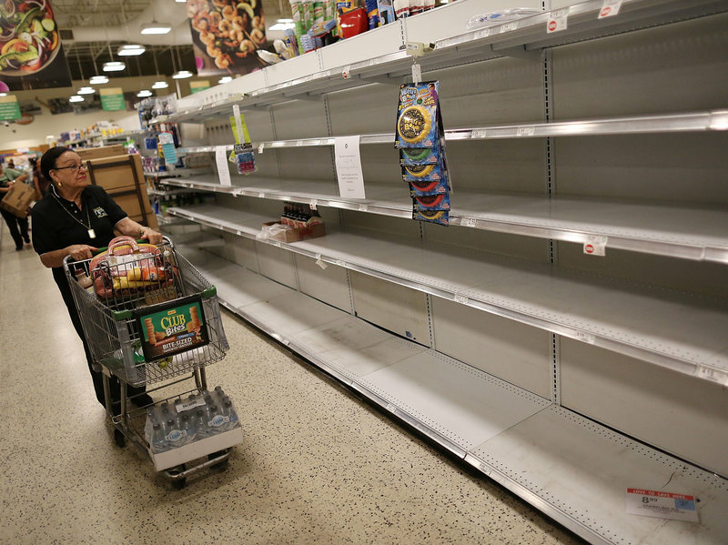 gettyimages-843439796-b8af4eaf5ea0eb16e74a713d951fb36617d74115-s800-c85.jpg Grocery store shelves are barren after selling out of bottled water on Wednesday in Miami.