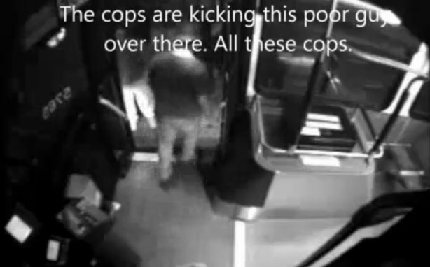 Still from a bus surveillance video showing eyewitnesses talking about the police altercation with a homeless man. The man later died.