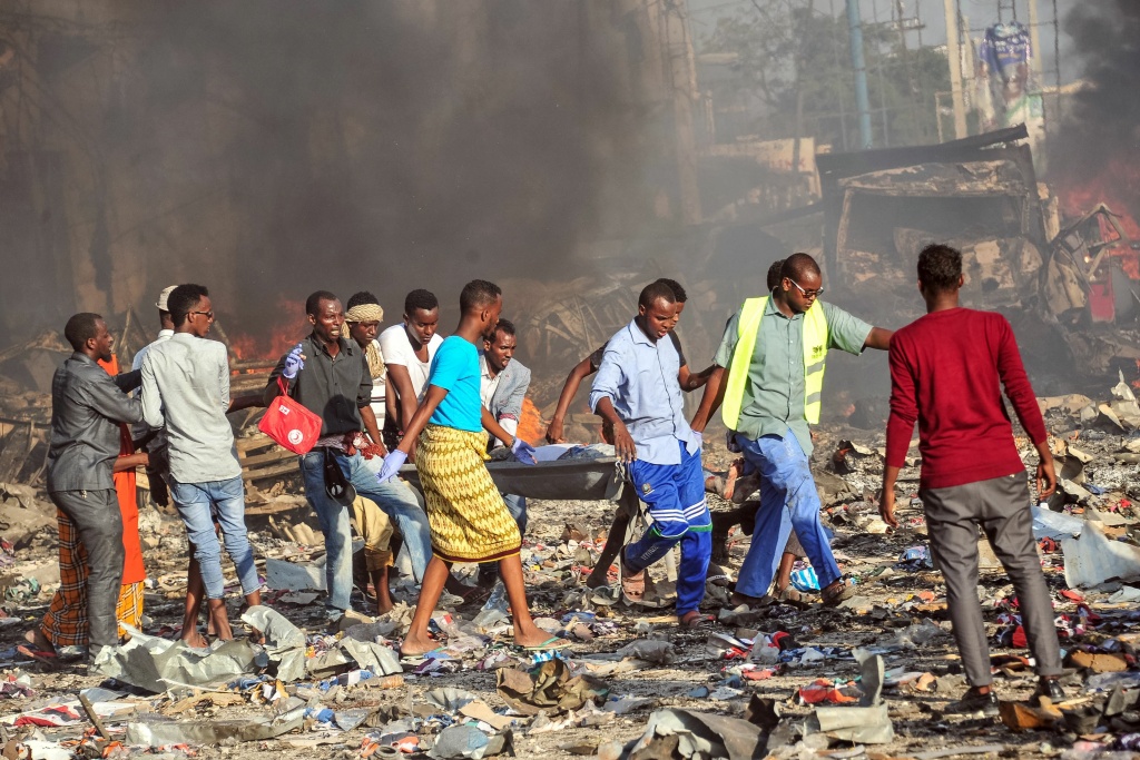 SOMALIA-BOMBINGS-CONFLICT Men carry a stretcher of after a truck bomb exploded in the center of Mogadishu on October 15, 2017.