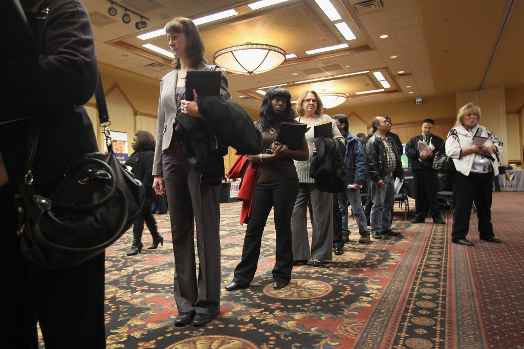 Job Seekers Look For Employment Opportunities At Career Fair Job applicants wait in line to meet potential employers at the