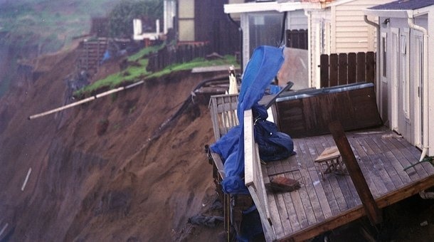 People from the village of Shiran, approxinately 480 miles north of the Peruvian capital Lima, view a damaged sewage line caused by flooding of the Chicana River due to heavy rains attributed to the 'El Nino' effect in 1998.