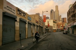 Mercer 14215 A man tows his cart down the street on Skid Row in Los Angeles.