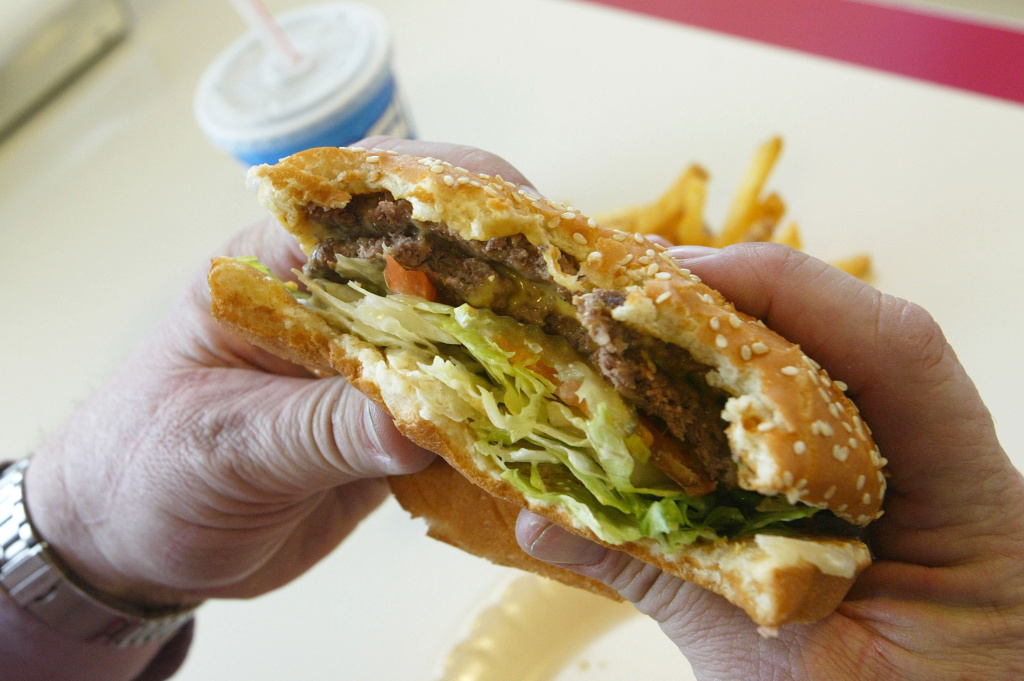 Steve Calhoun prepares to bite into a double cheeseburger at Majors Hamburgers December 28, 2003 in Yakima, Washington.