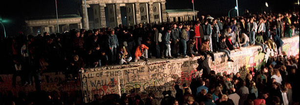 Thousands of young East Berliners gathering at the Berlin Wall, near the Brandenburg Gate (background) in this picture taken on Nov. 11, 1989. During the summer of 1989, 10s of thousands of East Germans fled the communist regime to a new life in the west.