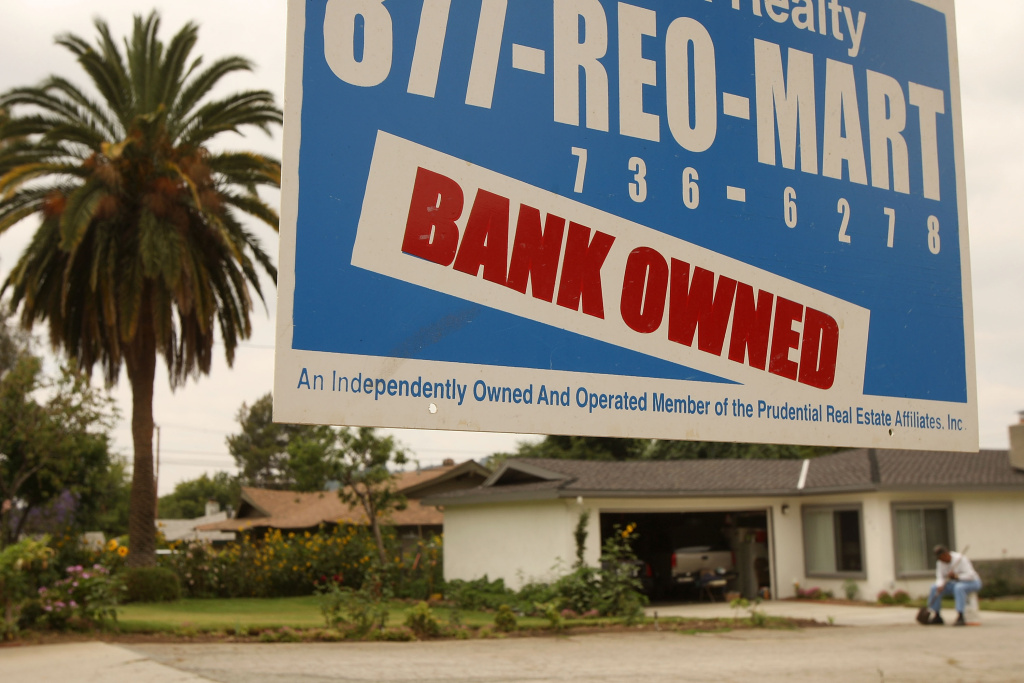 Foreclosures A realtor sign advertises a bank-owned house for sale in Pasadena. The U.S. government filed a lawsuit in District Court in Los Angeles, accusing the debt rating agency Standard & Poor's of fraud for giving high ratings to risky mortgage bonds that helped bring about the financial crisis.
(Photo by David McNew/Getty Images)